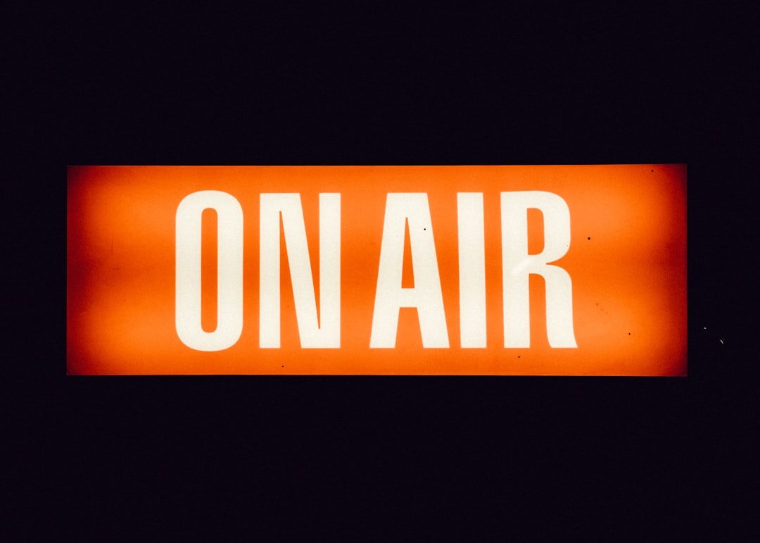 News presenter reading live broadcast at radio desk