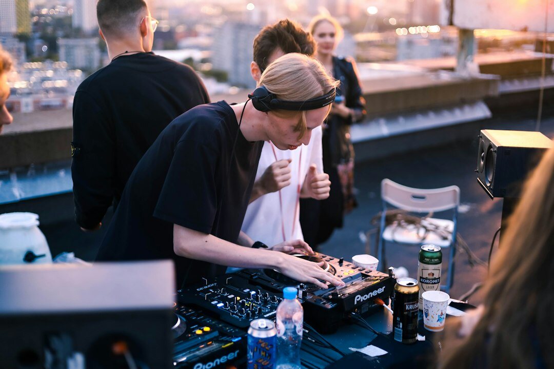 Small team collaborating around a mixing console